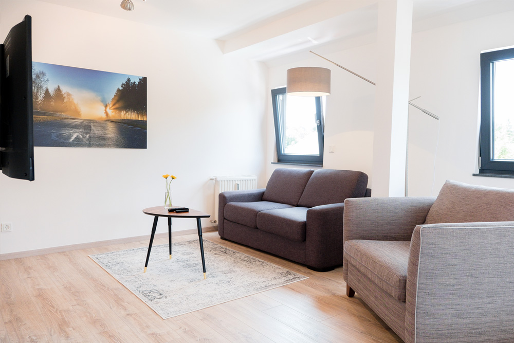 Comfortable living room in our of our hotel suites at Apex Nürburg.